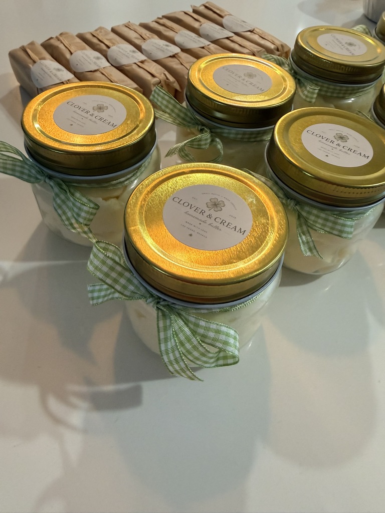 Clover butter jars tied with sage gingham ribbons alongside hand-wrapped butter